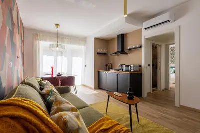 a living room with a couch and a kitchen at Yasmine Luxury Apartment in San Giovanni in Rome