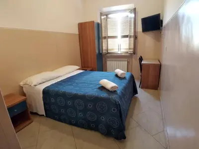 a bedroom with a bed with two towels on it at Cressy in Rome