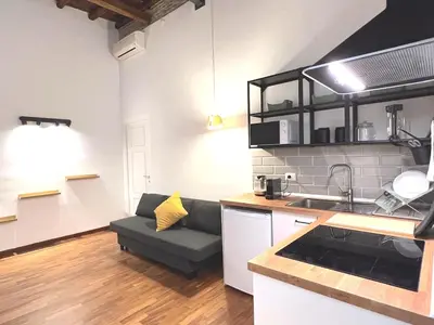 a kitchen and living room with a couch in it at Casa Polveriera at Colosseum in Rome