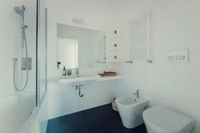 a white bathroom with a sink and a toilet at Fifi's Flaminio Panoramic Apartment 120mq in Rome
