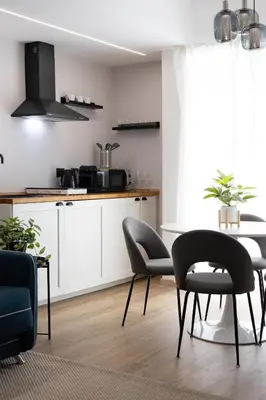 a kitchen with a table and chairs in a room at Aida Luxury Apartment in San Giovanni in Rome