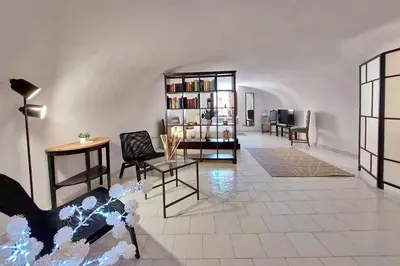 a living room with chairs and a book shelf at Eat Pray Stay Pantheon in Rome