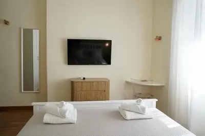 a bedroom with a bed with two white towels at CasaCoco con posto auto e 2 bagni in Rome