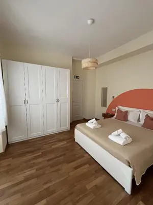 a bedroom with a large bed and white cabinets at CasaCoco con posto auto e 2 bagni in Rome