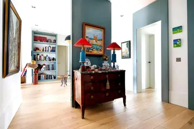 a living room with a dresser with two lamps on it at Appartamento Marissia in Rome