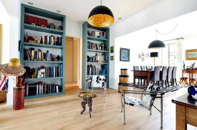a living room with blue book shelves at Appartamento Marissia in Rome