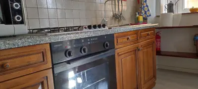 a kitchen with a stove and a counter top at Colosseum house jp in Rome
