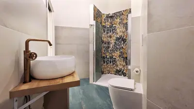 a bathroom with a sink and a toilet and a shower at DolceVite - Fontana Di Trevi in Rome