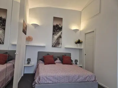 a bedroom with a bed and two pictures on the wall at Domus Tirso Mini Loft with independent entrance in Rome