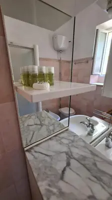 a bathroom with a sink and a counter top at Domus Merulana Bed and Breakfast in Rome