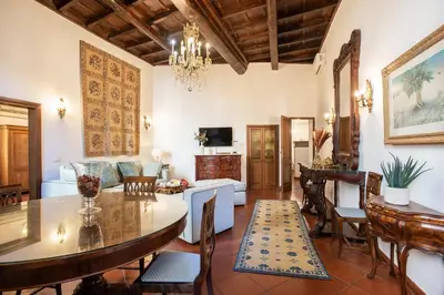 a living room with a table and chairs and a couch at Santa Caterina by the Pantheon - 2BR in Rome