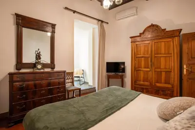 a bedroom with a bed and a dresser and a mirror at Santa Caterina by the Pantheon - 2BR in Rome