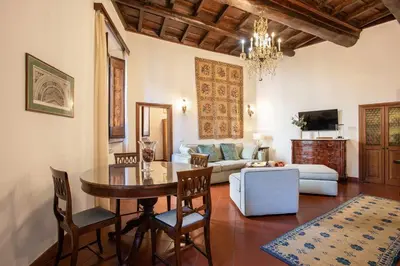 a living room with a table and a couch at Santa Caterina by the Pantheon - 2BR in Rome