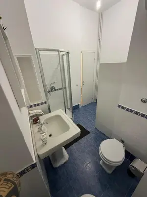 a white bathroom with a toilet and a sink at Casa Achille - Piazza Bologna in Rome