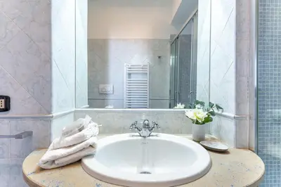 a balcony with a table and chairs on a building at iFlat Spanish Steps Elegant & Spacious Apartment in Rome
