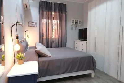 a small bedroom with a bed and a television at Rome - Oasis with Private Garden in Parco Pamphilj in Rome