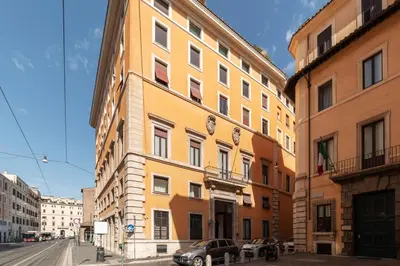 a yellow building on the side of a street at Torre Argentina - Charme Holidays in Rome