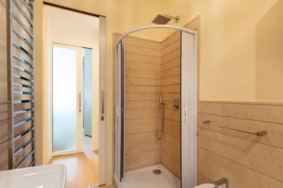 a bathroom with a shower with a glass door at Casa Giuliana 91 by Hili in Rome