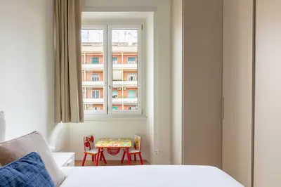 a bedroom with a bed and a table and a window at Casa Giuliana 91 by Hili in Rome