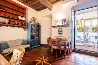 a living room with a table and a couch at Trastevere Enchanting Apartment in Rome