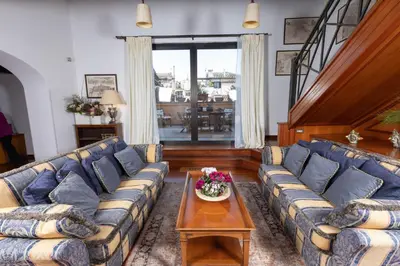 a living room with a blue couch and a table at Pantheon Rondanini Luxury Penthouse in Rome