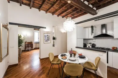 a kitchen and living room with a table and chairs at The Best Rent - Characteristic three-room apartment near Piazza Navona in Rome