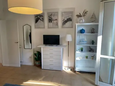 a room with a desk with a television on it at Gemelli Roma House Apartment in Rome