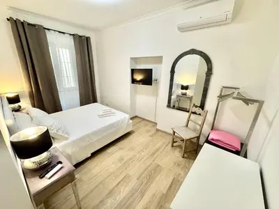a hotel room with a bed and a mirror at Mellini Escape in Rome