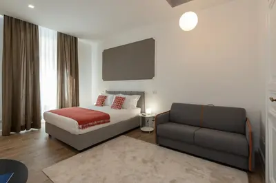 a bedroom with a bed and a couch at Nox in Rome