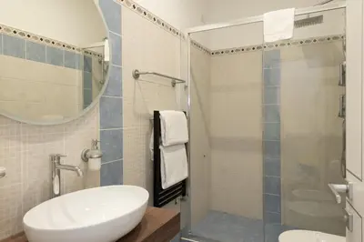a bathroom with a sink and a shower with a mirror at Nox in Rome