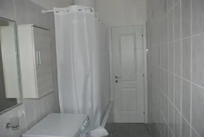 a white bathroom with a shower and a sink at Casa Tony in Rome