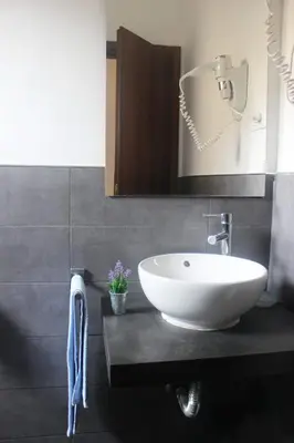 a bathroom with a white sink and a mirror at B&B Isolatiberina in Rome