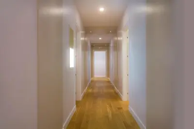 an empty hallway with white walls and wood floors at Ripense In Trastevere in Rome