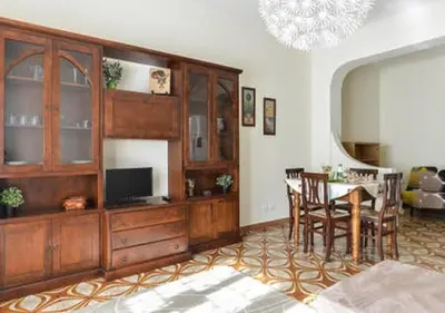 a living room with a dining table and a entertainment center at La Casa di Eva in Rome