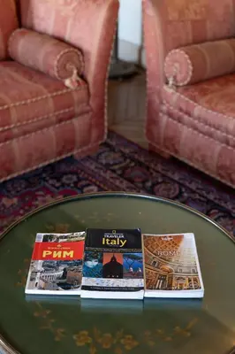 two books sitting on a table in a living room at Rome Downtown Suite Bed and Breakfast Aracoeli in Rome