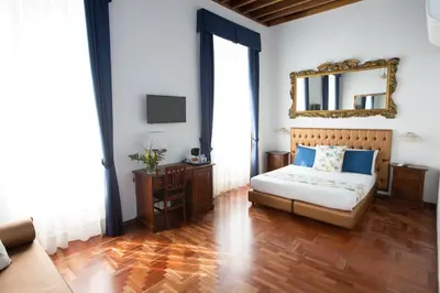 a bedroom with a bed and a mirror on the wall at AD2015 Guest House in Rome