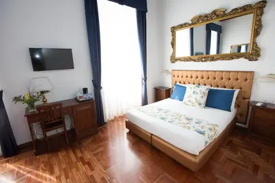 a bedroom with a bed with a mirror on the wall at AD2015 Guest House in Rome