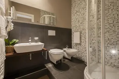 a bathroom with a toilet and a sink and a shower at NG Guest House Roma San Pietro in Rome