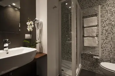 a bathroom with a sink and a toilet and a shower at NG Guest House Roma San Pietro in Rome