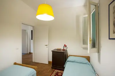 a bedroom with a bed and a lamp and a table at Borgo Panoramico - 3-Bedroom Apartment with Terrace - LOCAPPART in Rome