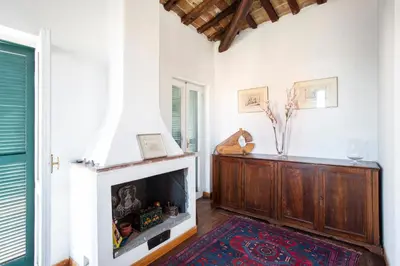 a living room with a fireplace and a window at Borgo Panoramico - 3-Bedroom Apartment with Terrace - LOCAPPART in Rome