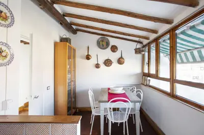 a dining room with a table and chairs at Borgo Panoramico - 3-Bedroom Apartment with Terrace - LOCAPPART in Rome