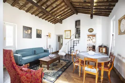 a living room with a blue couch and a table at Borgo Panoramico - 3-Bedroom Apartment with Terrace - LOCAPPART in Rome