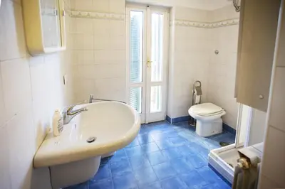 a bathroom with a sink and a toilet at Borgo Panoramico - 3-Bedroom Apartment with Terrace - LOCAPPART in Rome