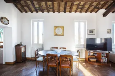 a dining room with a table and a tv at Borgo Panoramico - 3-Bedroom Apartment with Terrace - LOCAPPART in Rome