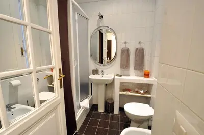 a bathroom with a toilet and a sink and a mirror at Casa Visconti in Rome