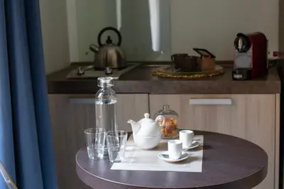a table with a tea pot and glasses on a counter at Pia Domus in Rome