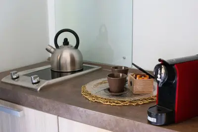a tea kettle on a counter next to a microwave at Pia Domus in Rome