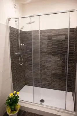 a shower with a glass door in a bathroom at Pia Domus in Rome