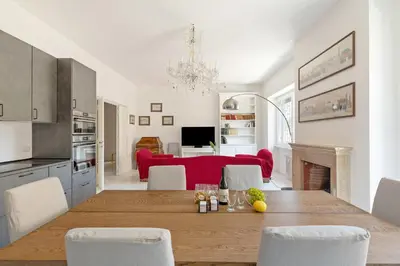 a kitchen and living room with a table and a red couch at Bright Family 5BR Apartment in Parioli in Rome